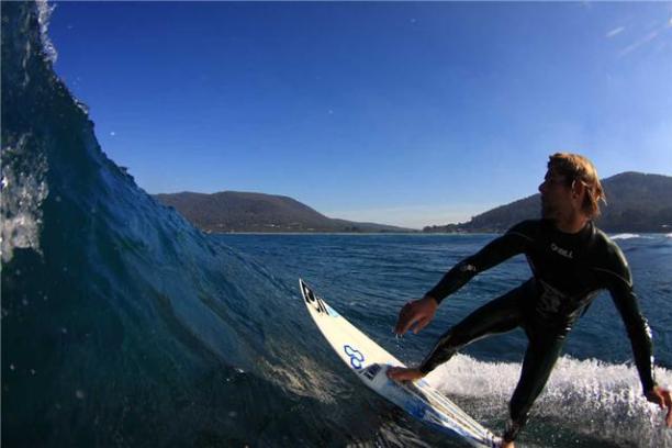 a man riding a wave on a surfboard in the water