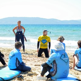 a group of people sitting at a beach