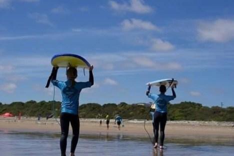 a person standing next to a body of water