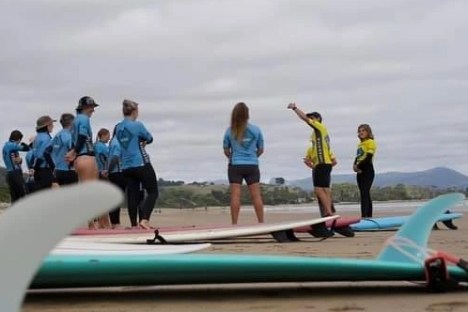 a group of people sitting at a beach